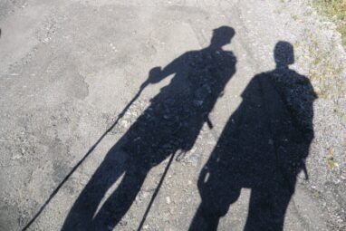 Schatten zweier Wanderer mit Treckingstöcken